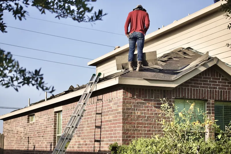 Professional roofer working on a residential roof in Chevy Chase